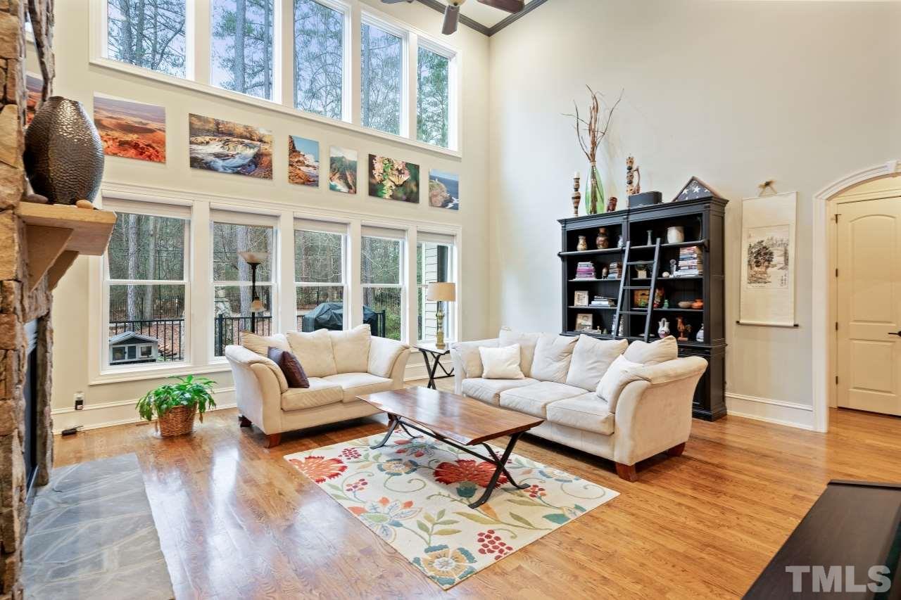 6017 Reedy Creek Road Raleigh, NC 27607 - Photo 8 of 30 Bright large space with vaulted beamed wood ceilings, and a 2 story double sided stone fireplace. Perfect for entertaining and relaxing.