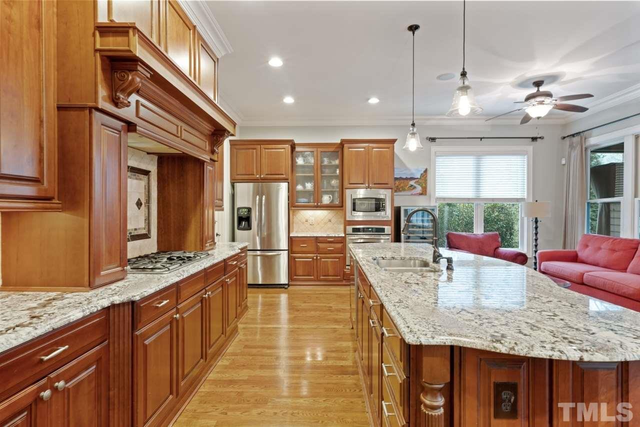6017 Reedy Creek Road Raleigh, NC 27607 - Photo 9 of 30 Stainless steel appliances, granite, bright sitting area, island seating and a sun-filled breakfast room.