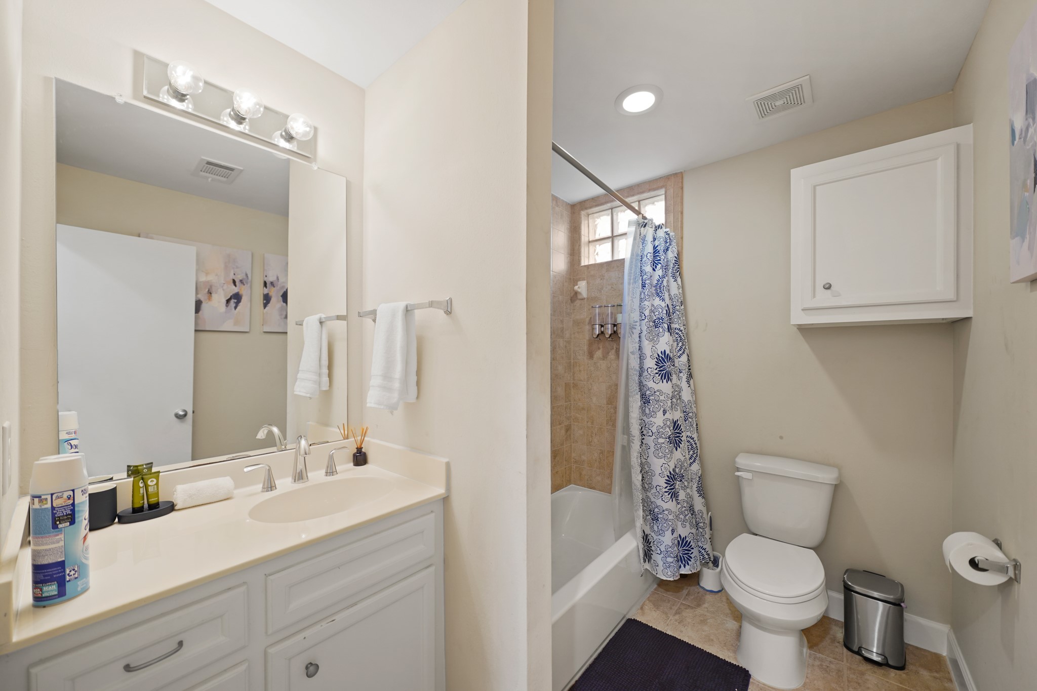 8705 Bryam Street, Unit 104 Houston, TX 77061 - Photo 14 of 16 Conveniently located off the main living space, this sleek full bathroom features a pedestal sink and neutral tile.