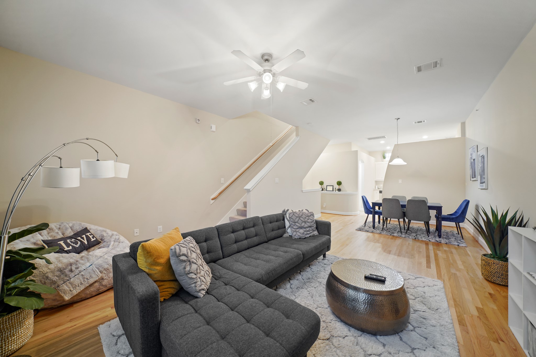 8705 Bryam Street, Unit 104 Houston, TX 77061 - Photo 7 of 16 Spacious and bright, this living area features high ceilings and plush carpet, with a defined layout that offers privacy from the kitchen while maintaining a cozy, connected flow to the dining area.