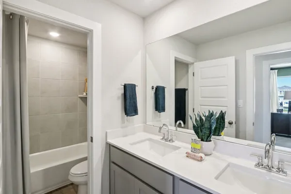 a bathroom with a granite countertop sink a toilet and shower
