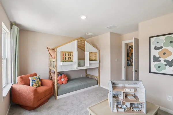 a bedroom with furniture and a window