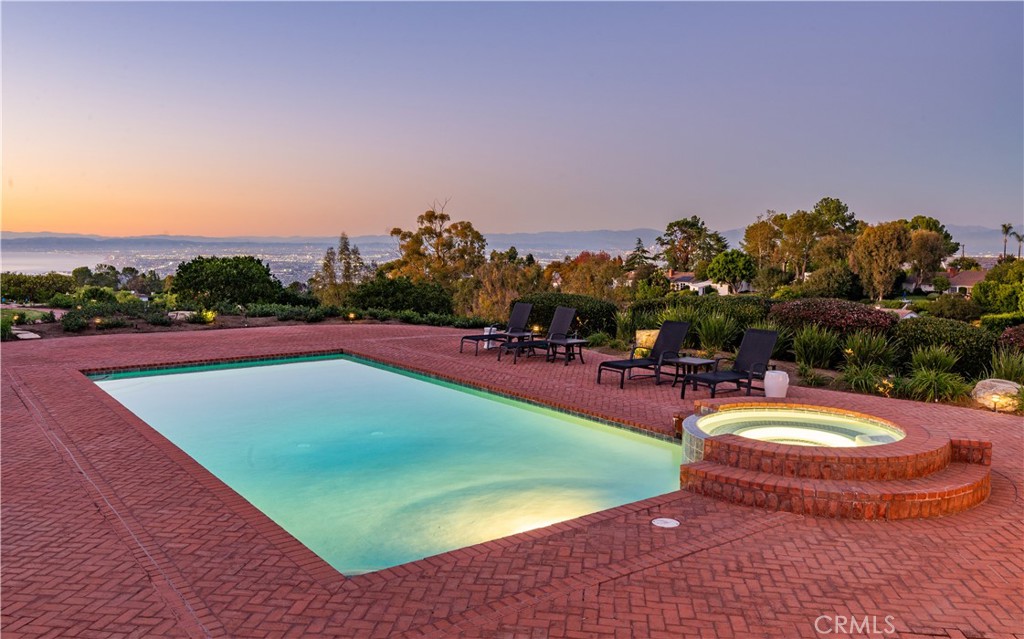 34 Crest Rolling Hills Palos Verdes Peninsula, CA 90274 - Photo 9 of 35 a view of a swimming pool with a table and chairs