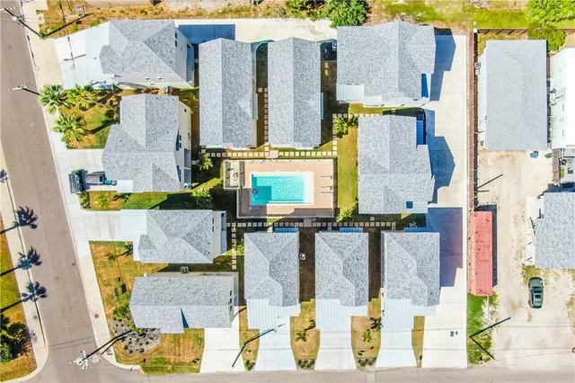 an aerial view of residential houses with outdoor space