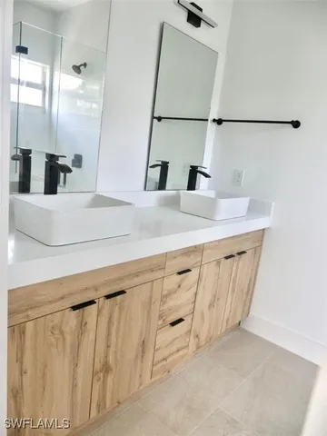 a bathroom with a sink vanity and mirror