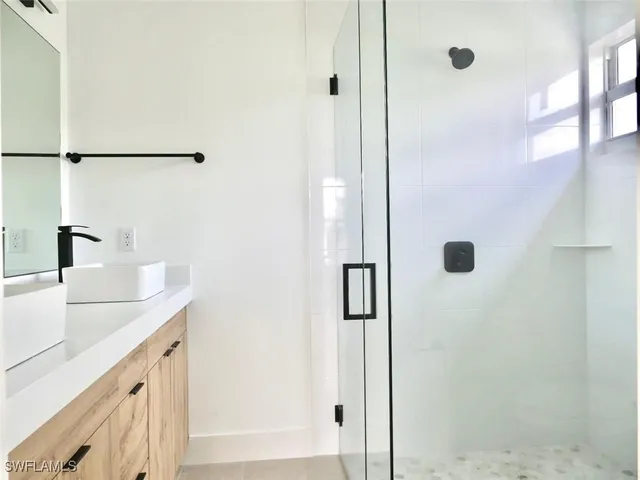 a bathroom with a sink and mirror
