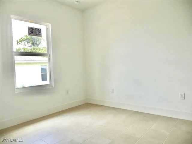 a view of a small space with wooden floor and a window