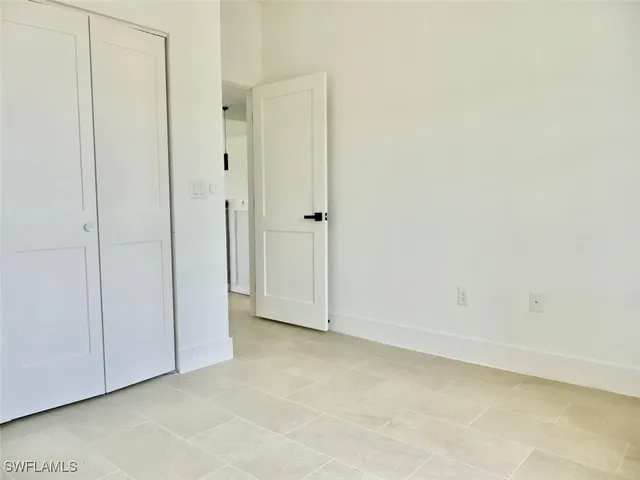 an empty room with closet area