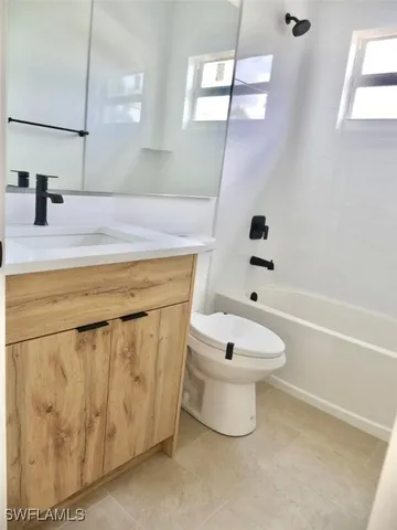 a bathroom with a toilet a sink and bathtub