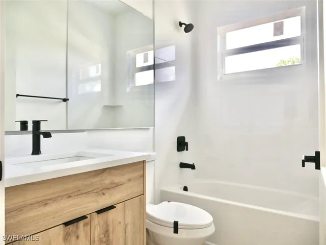a bathroom with a sink a toilet and a bathtub