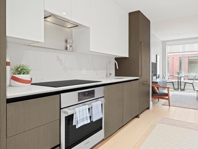 a kitchen with stainless steel appliances a sink and cabinets