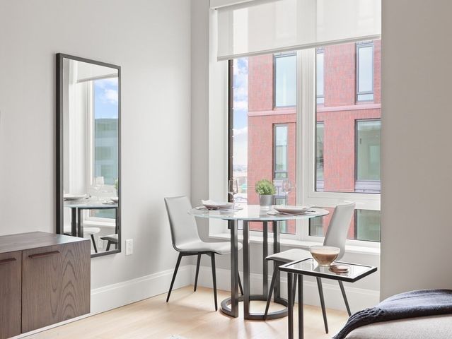 a view of a dining room with furniture and window