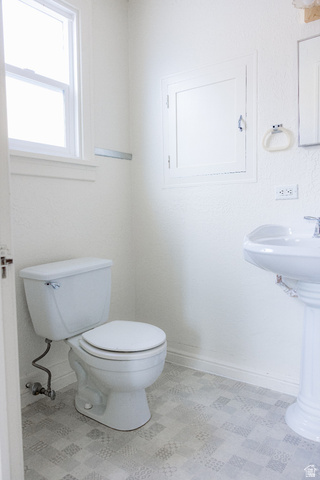 69 South Main Street Manti, UT 84642 - Photo 31 of 44 Bathroom with a pedestal sink, white toilet, and patterned tile-look flooring