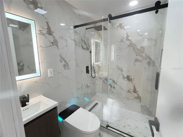 a bathroom with a sink toilet and shower