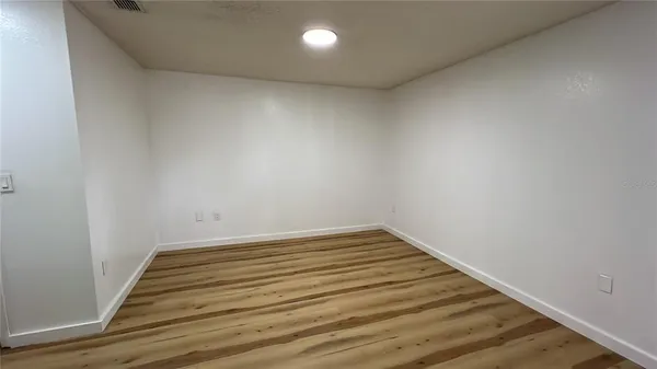 a view of a room with wooden floor