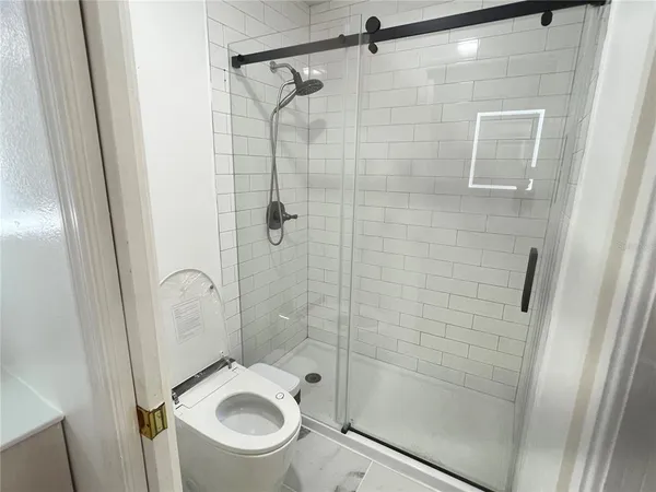 a bathroom with a toilet and a shower