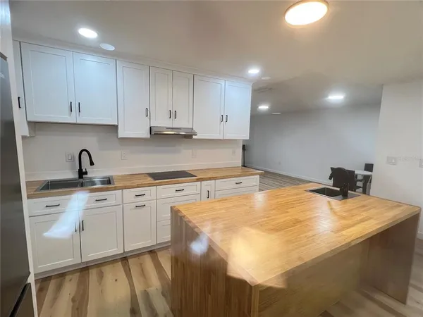 a kitchen with a sink cabinets and appliances