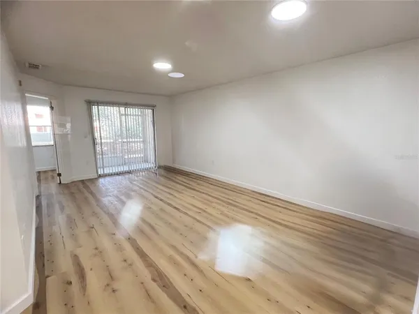 wooden floor in an empty room with a window