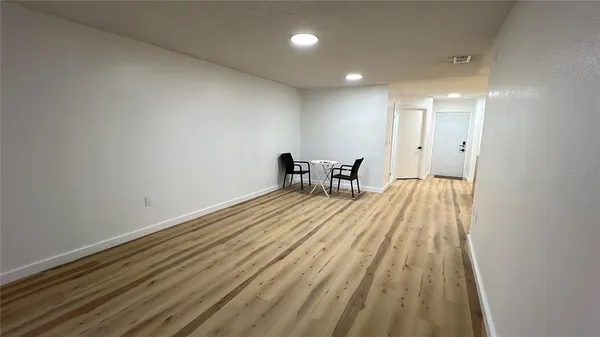 a view of a room with wooden floor and bench