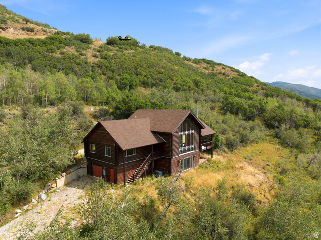 5404 Mountain View Road Coalville, UT 84017 - Photo 47 of 50 Brown-sided home with a prominent pitched roof and a multi-level deck