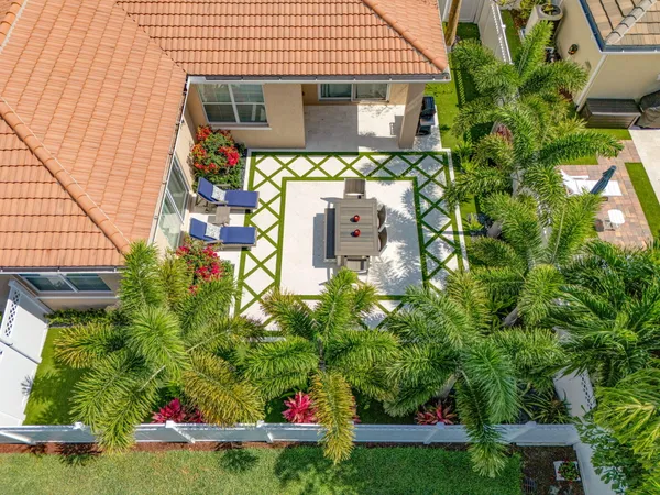 a front view of a house with a yard and potted plants