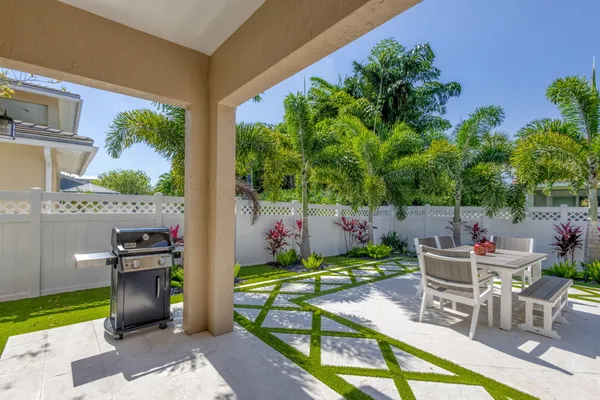 a view of a chairs and table in backyard