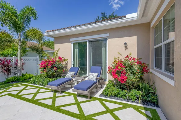 a flower garden is sitting in front of house