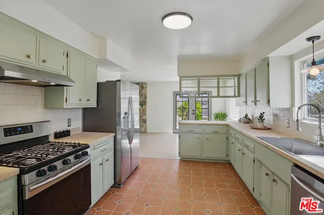 a kitchen with a sink stove and refrigerator