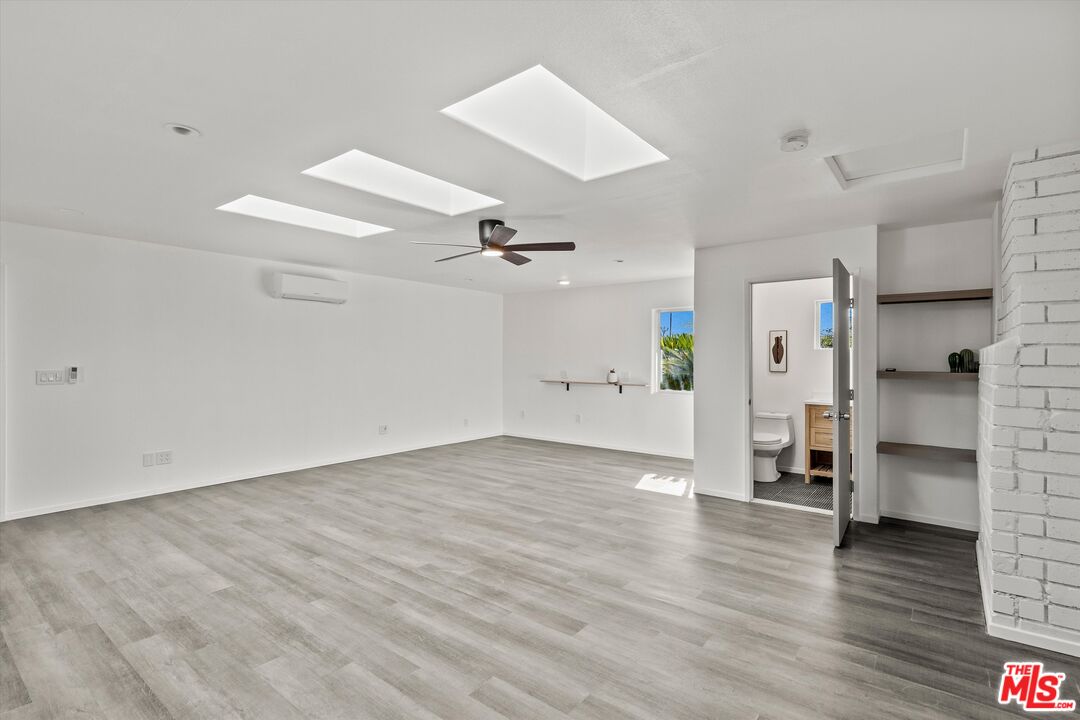 6391 Ruth Drive Yucca Valley, CA 92284 - Photo 18 of 56 an empty room with wooden floor and a ceiling fan