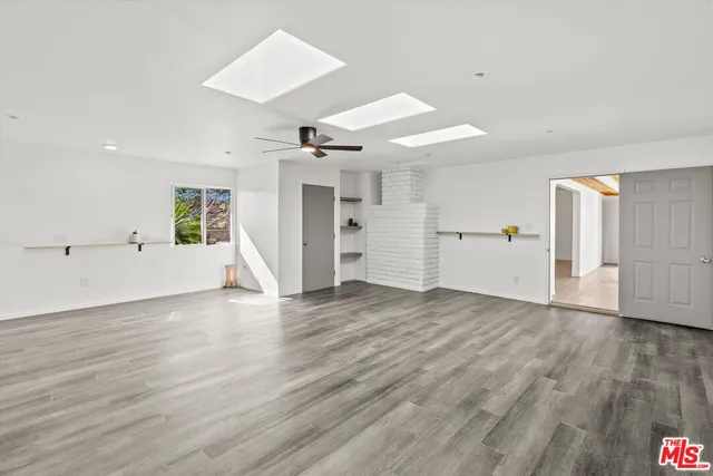 an empty room with furniture and window