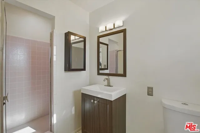 en empty room with window and wooden floor