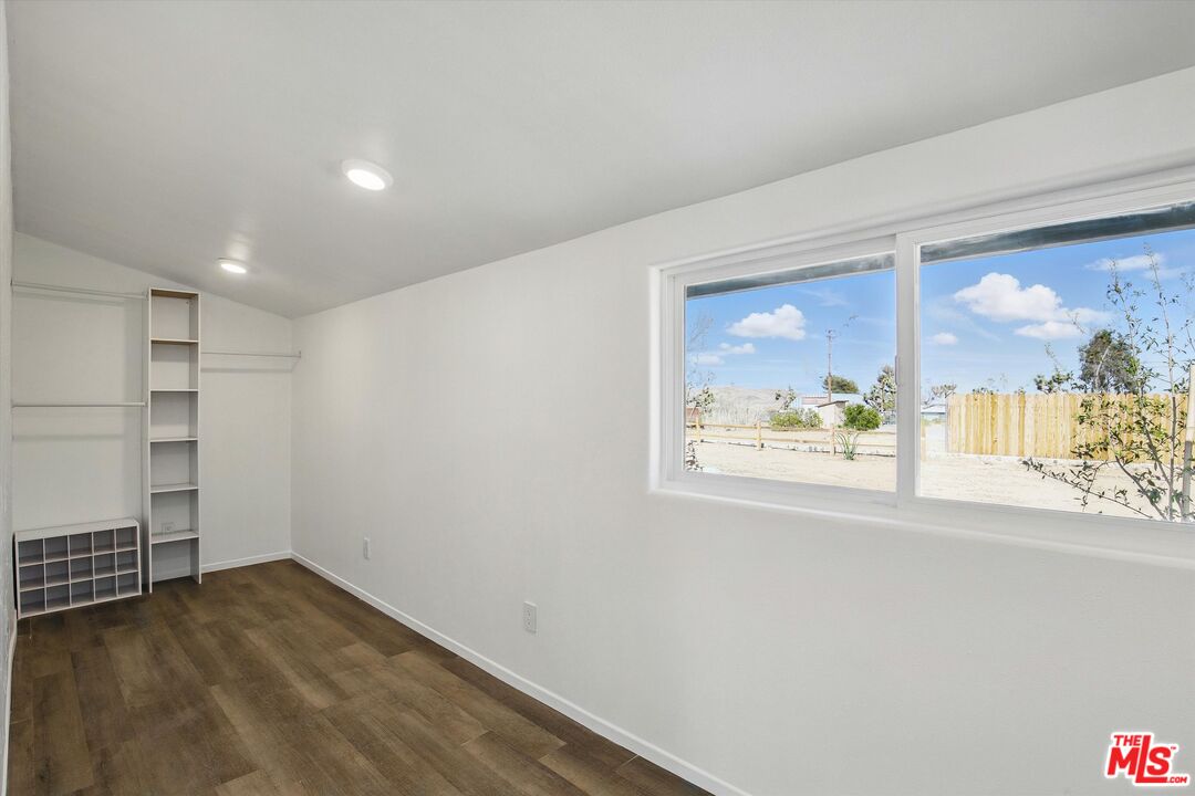 6391 Ruth Drive Yucca Valley, CA 92284 - Photo 29 of 56 en empty room with window and wooden floor