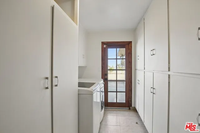 a view of a house with wooden fence