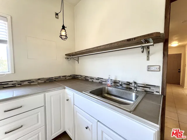 a view of a storage & utility room with a sink