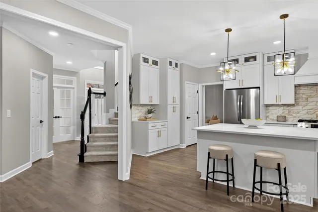 a bathroom with a sink toilet vanity and shower