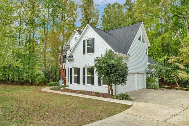 a view of a hallway with wooden floor and dining room