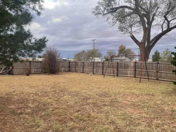 a backyard of a house with yard and barbeque oven
