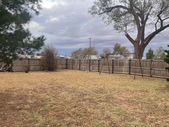 a backyard of a house with yard and barbeque oven