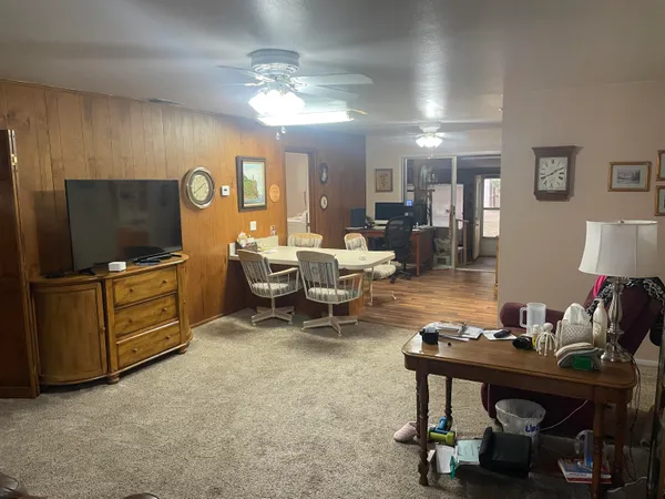a bedroom with furniture and a flat screen tv