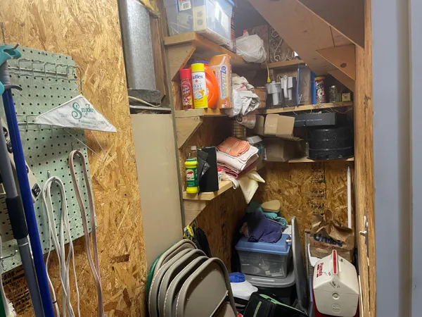 a kitchen with a refrigerator and white cabinets