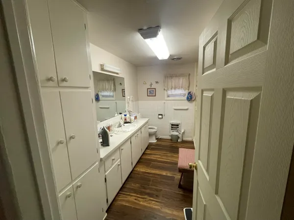a spacious bedroom with a bed and a chandelier