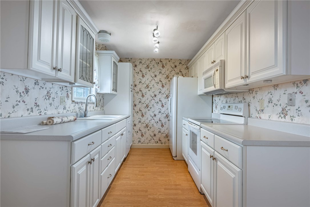 6300 Carnation Road Dayton, OH 45449 - Photo 13 of 35 This charming kitchen offers bright cabinetry, ample counter space, and a functional layout.