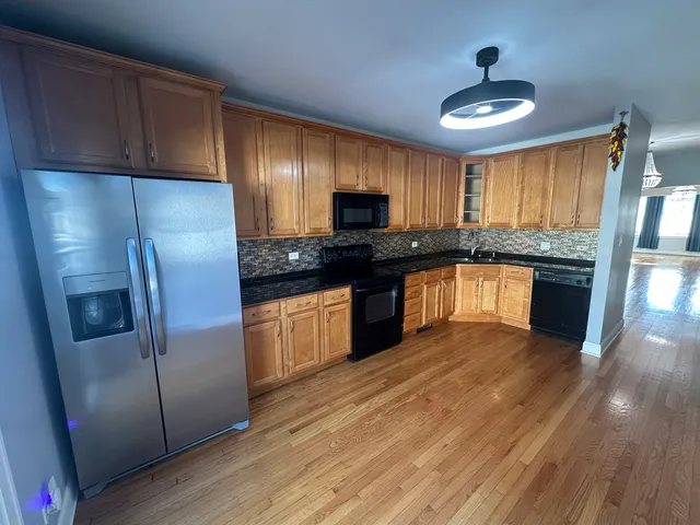a kitchen with granite countertop stainless steel appliances and wooden cabinets