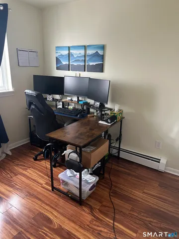 a living room with furniture and wooden floor