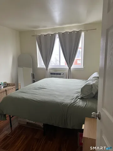 a bedroom with a bed window and a desk