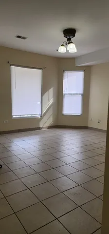 a view of a livingroom with an empty space and a window