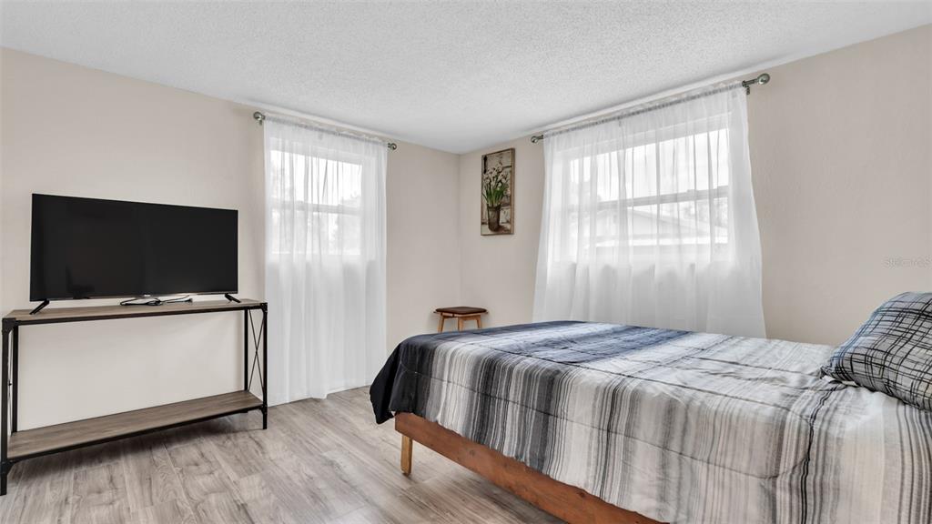 14832 Atlantic Avenue Hudson, FL 34667 - Photo 17 of 37 a bedroom with a bed and a flat screen tv