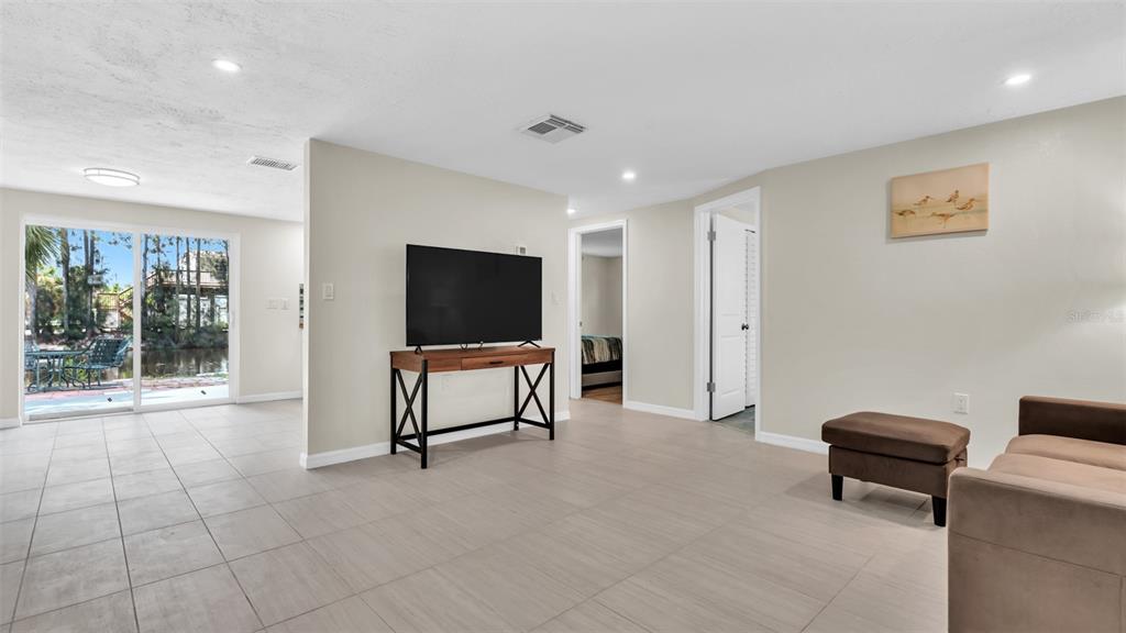 14832 Atlantic Avenue Hudson, FL 34667 - Photo 10 of 37 a living room with furniture and a flat screen tv