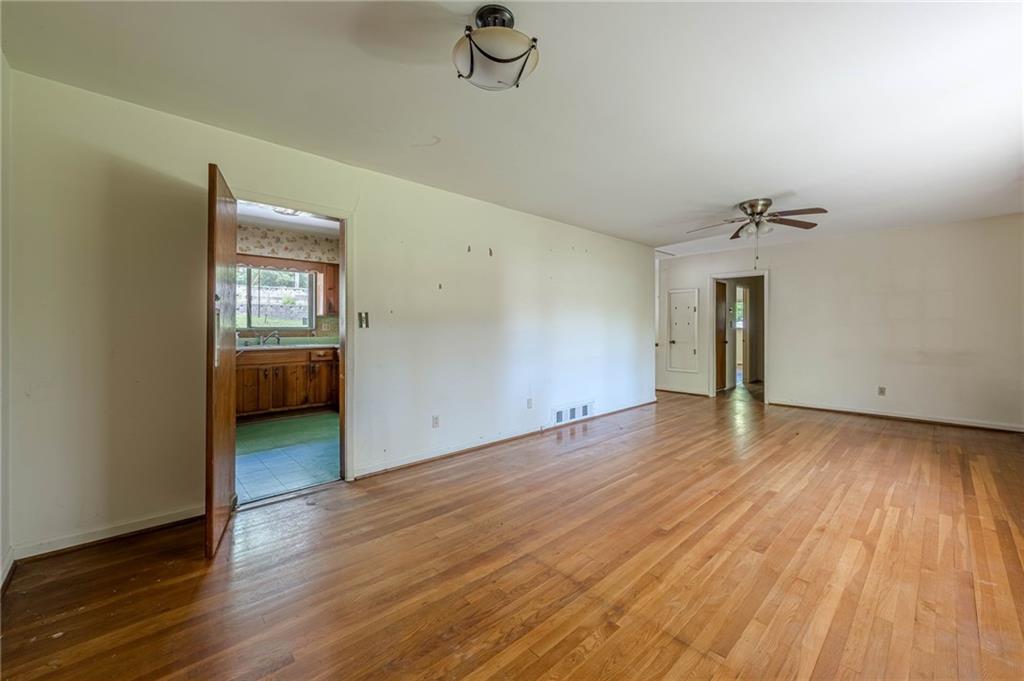1502 North Druid Hills Road Brookhaven, GA 30319 - Photo 14 of 46 wooden floor in an empty room with a window