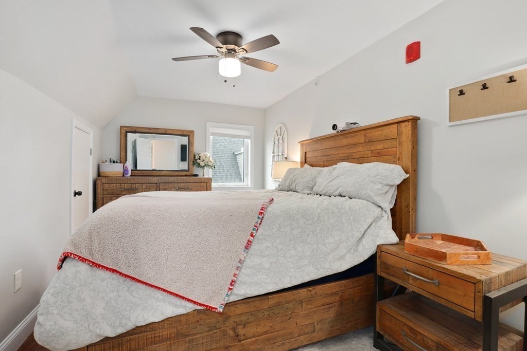 114 Waverly Street, Unit 3 Everett, MA 02149 - Photo 12 of 18 a bedroom with a bed and a chandelier